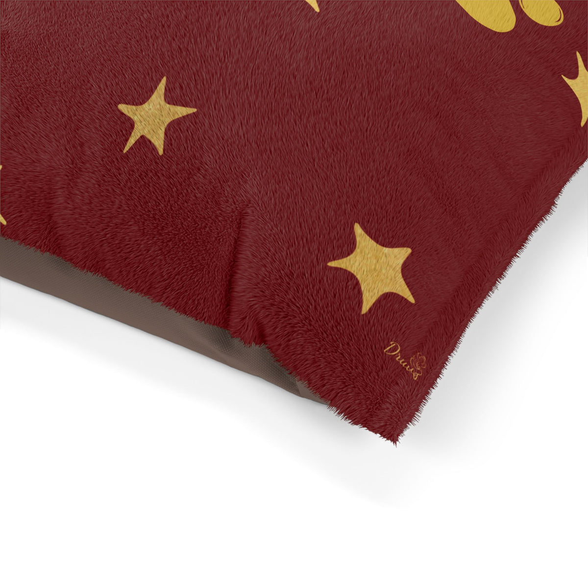 Corner detail of red pet bed with gold-colored star print