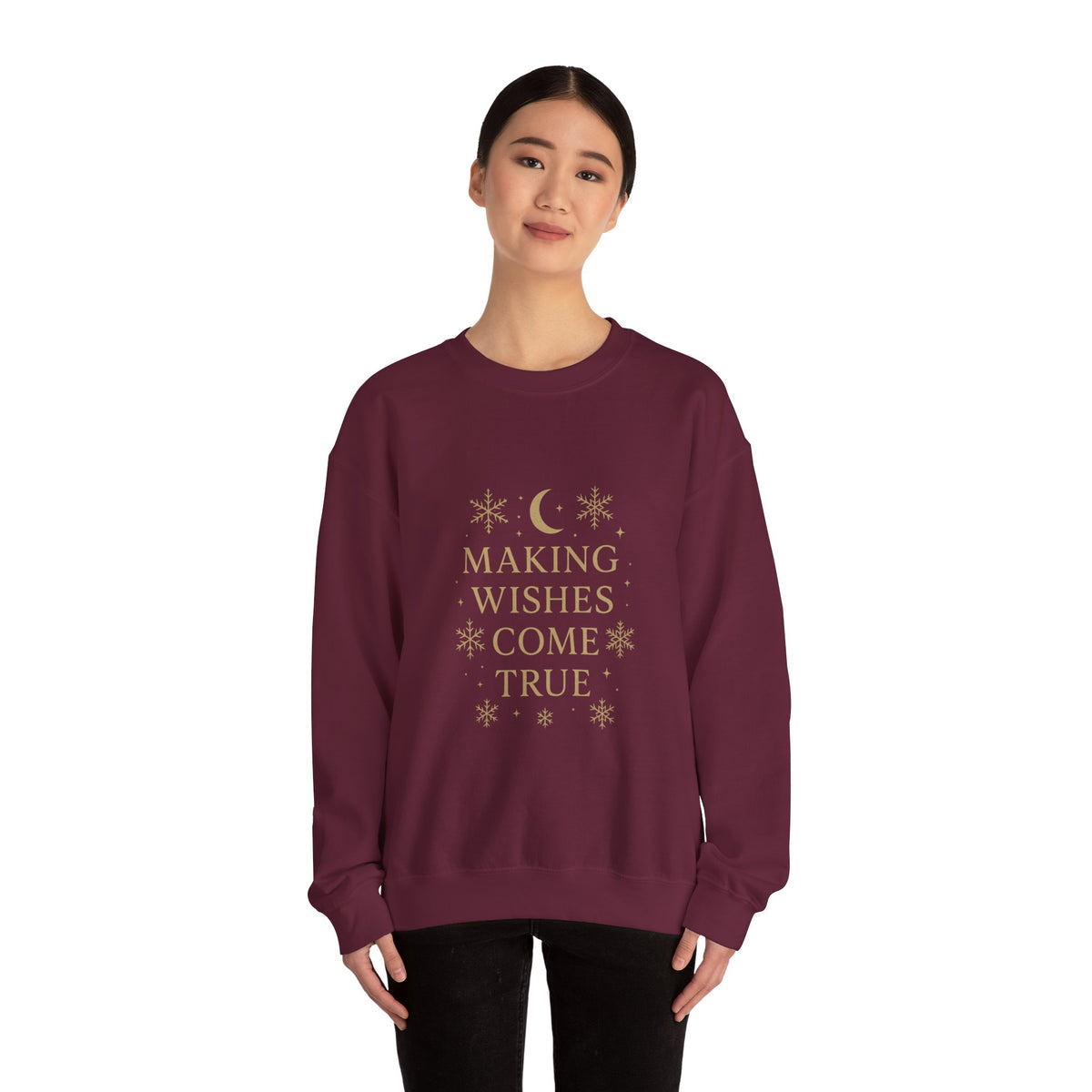 Model wearing a maroon Making Wishes Come True moon and snowflake sweatshirt