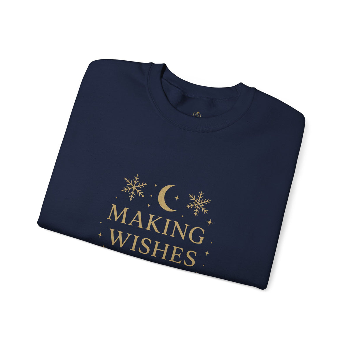 Folded navy sweatshirt showing Making Wishes Come True moon and snowflake print