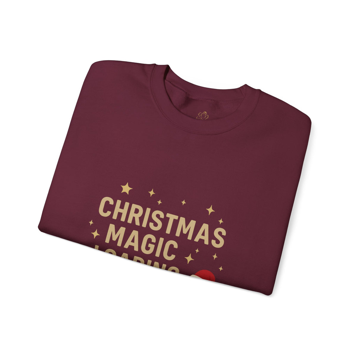 Folded maroon sweatshirt showing Christmas Magic Loading Santa hat print