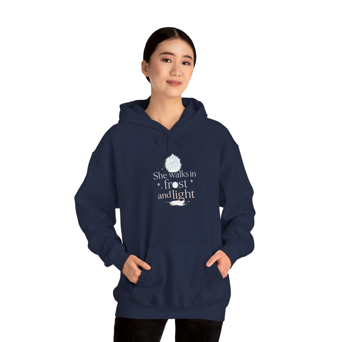 Folded navy hoodie showing the She Walks in Frost and Light moon print