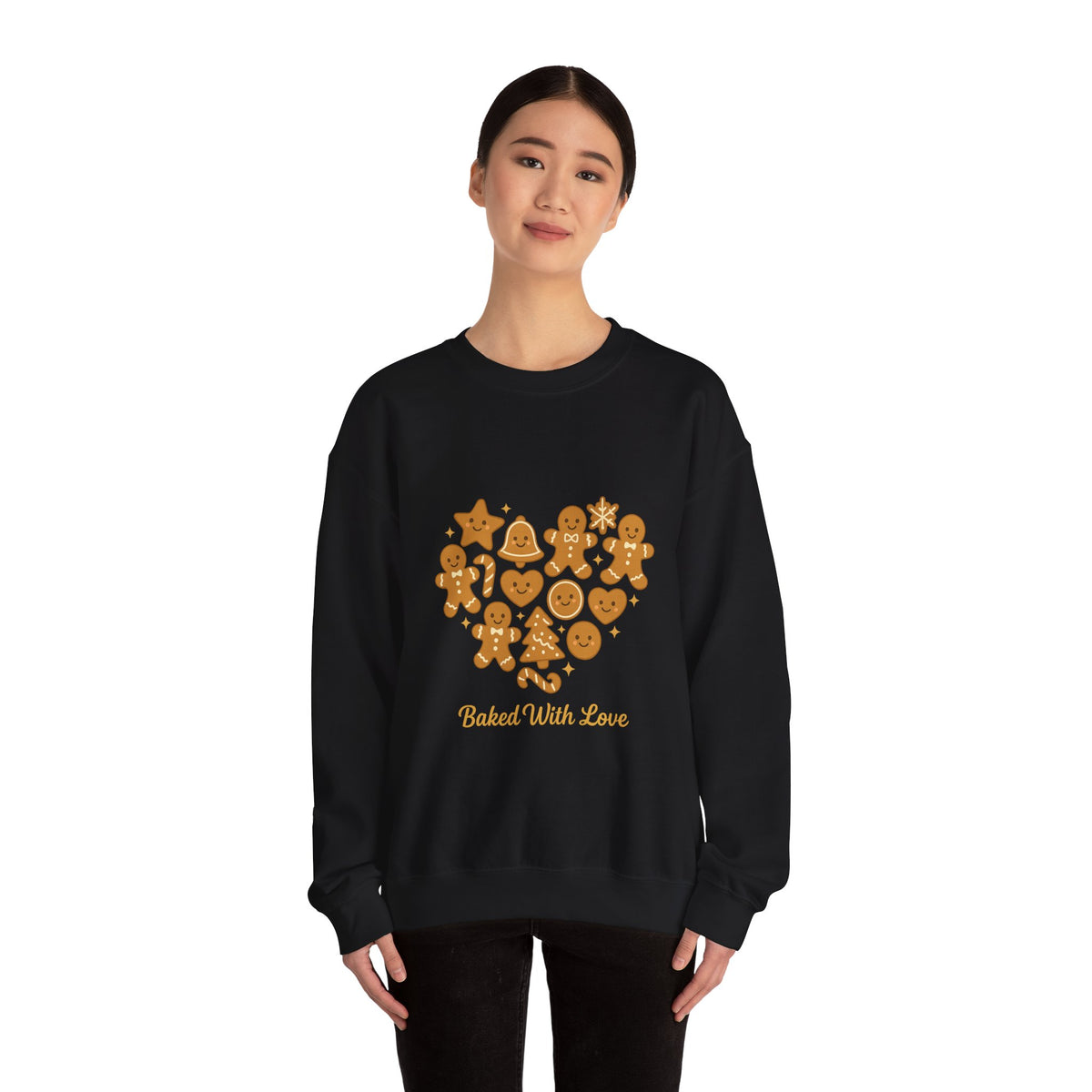 Model wearing a black Baked With Love gingerbread heart sweatshirt