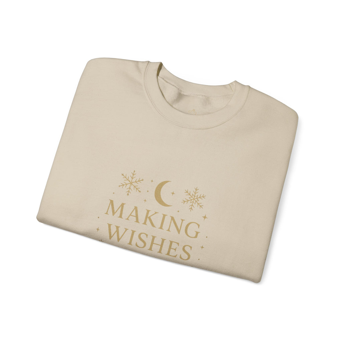 Folded sand sweatshirt showing Making Wishes Come True moon and snowflake print
