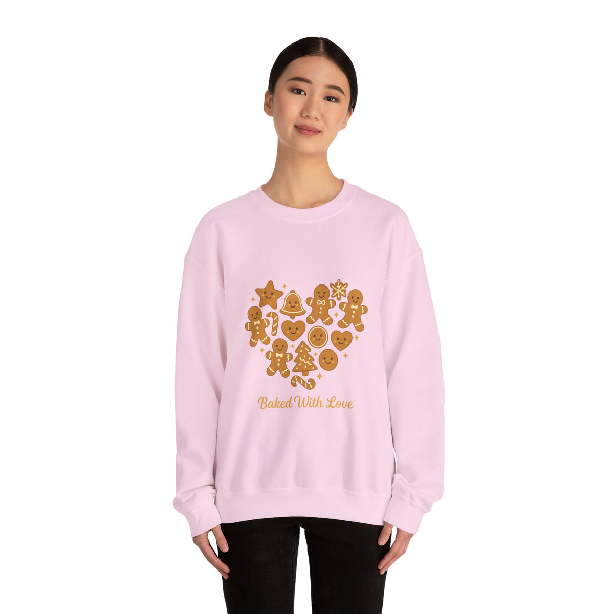 Model wearing a light pink Baked With Love gingerbread heart sweatshirt