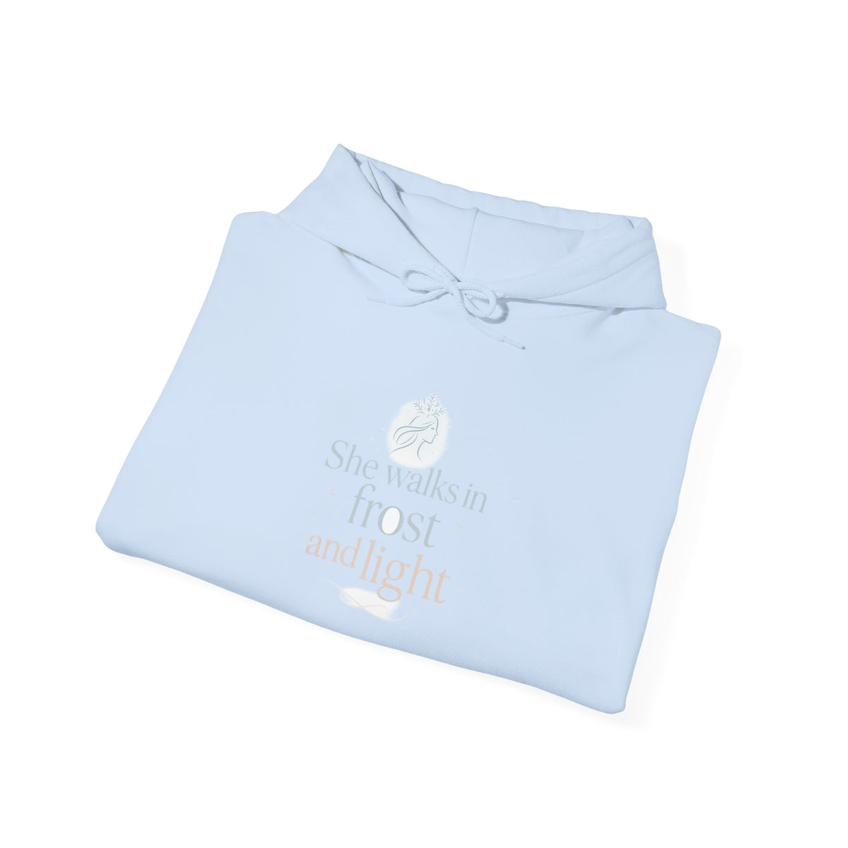 Folded light blue hoodie showing the She Walks in Frost and Light moon print