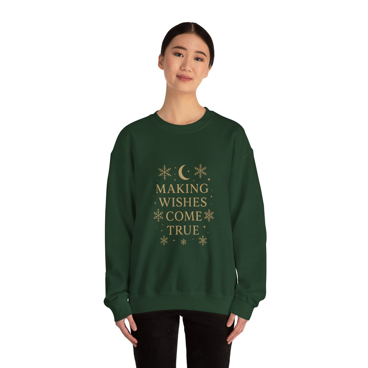 Model wearing a forest green Making Wishes Come True moon and snowflake sweatshirt