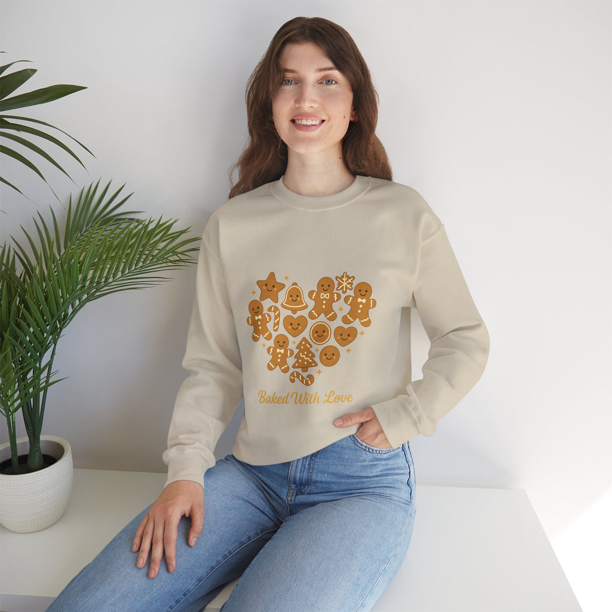 Model wearing a sand Baked With Love gingerbread heart sweatshirt