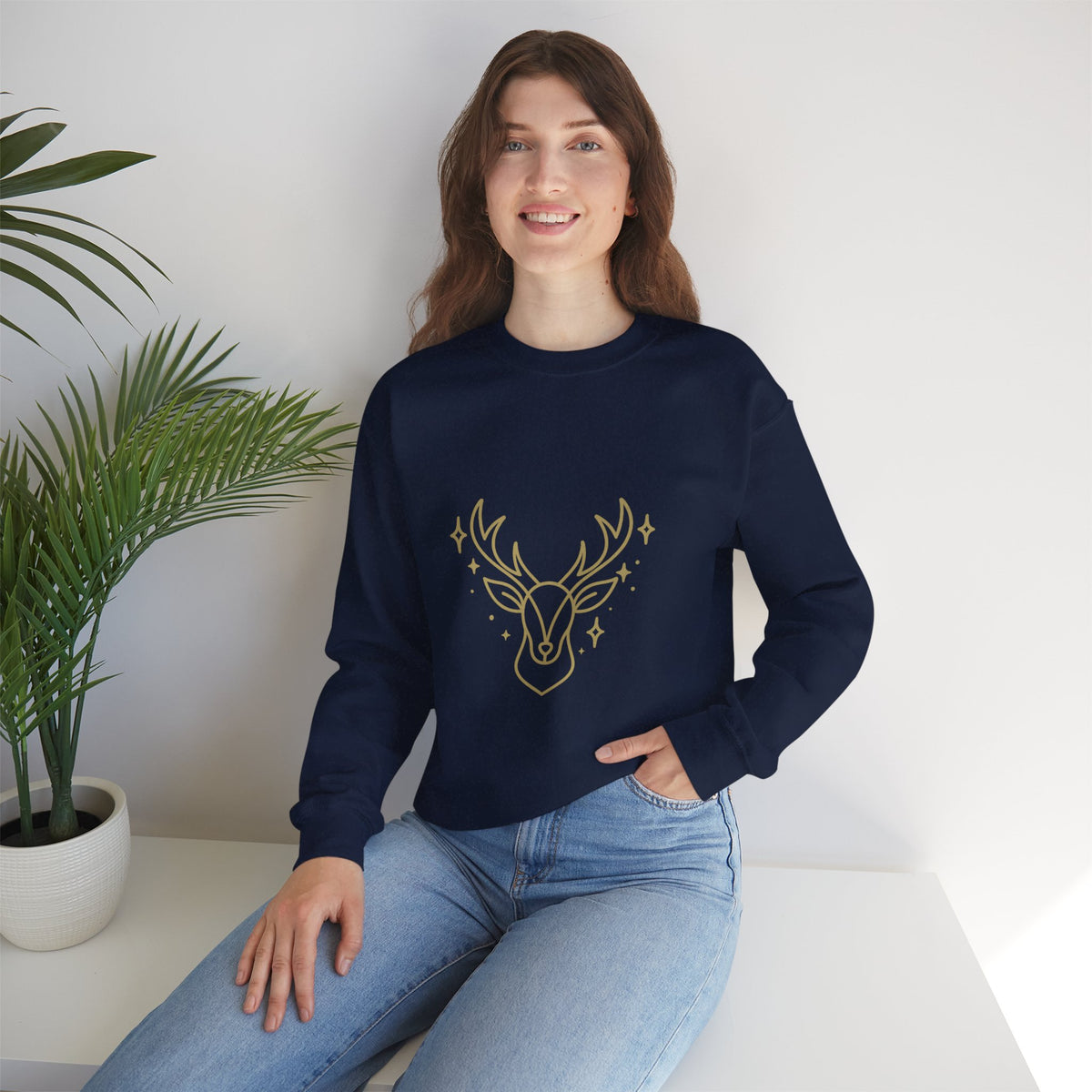Model wearing a navy minimalist gold-colored reindeer sweatshirt