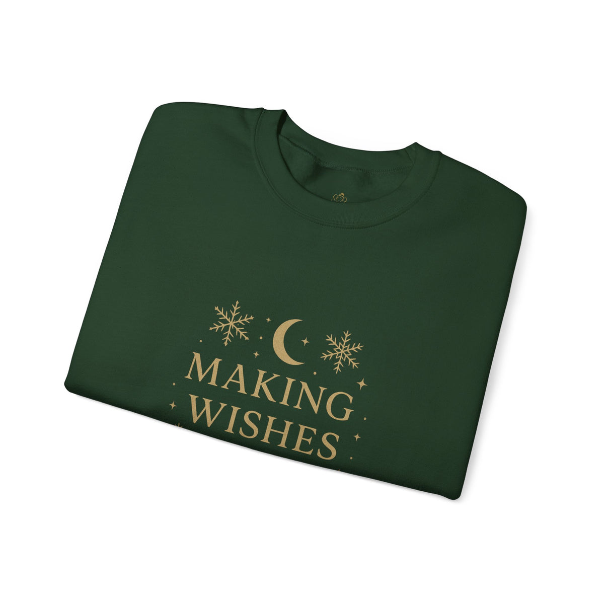Folded forest green sweatshirt showing Making Wishes Come True moon and snowflake print