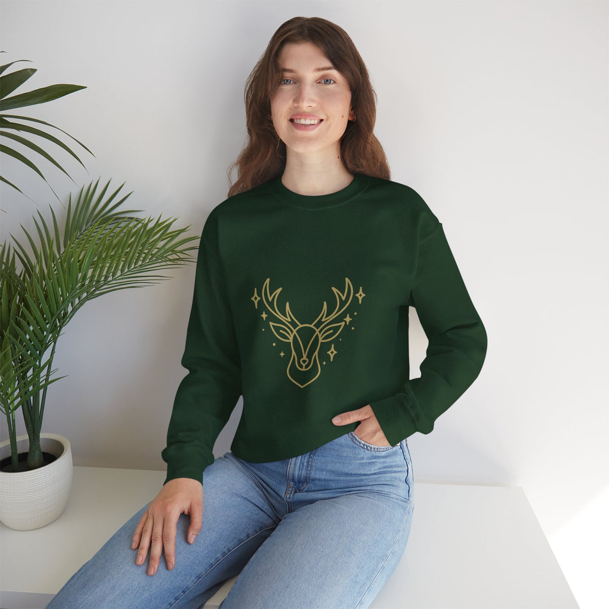 Model wearing a forest green minimalist gold-colored reindeer sweatshirt