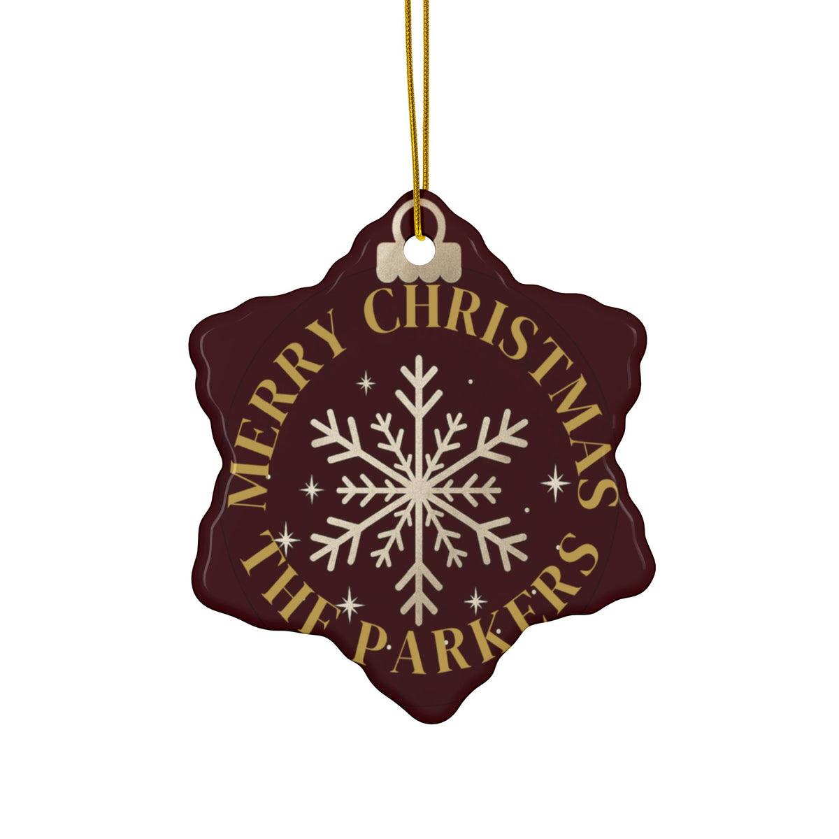 Maroon snowflake-shaped ornament with "Merry Christmas" and an example family name in gold