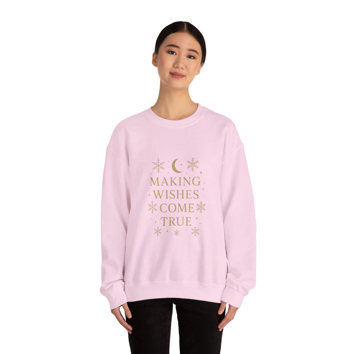 Model wearing a light pink Making Wishes Come True moon and snowflake sweatshirt