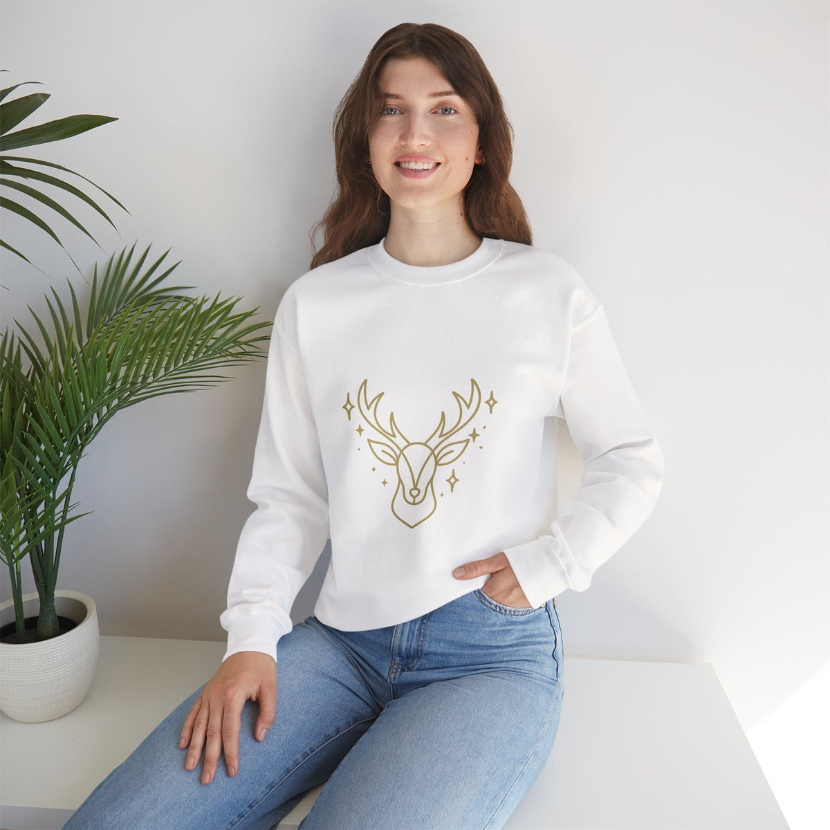 Model wearing a white minimalist gold-colored reindeer sweatshirt