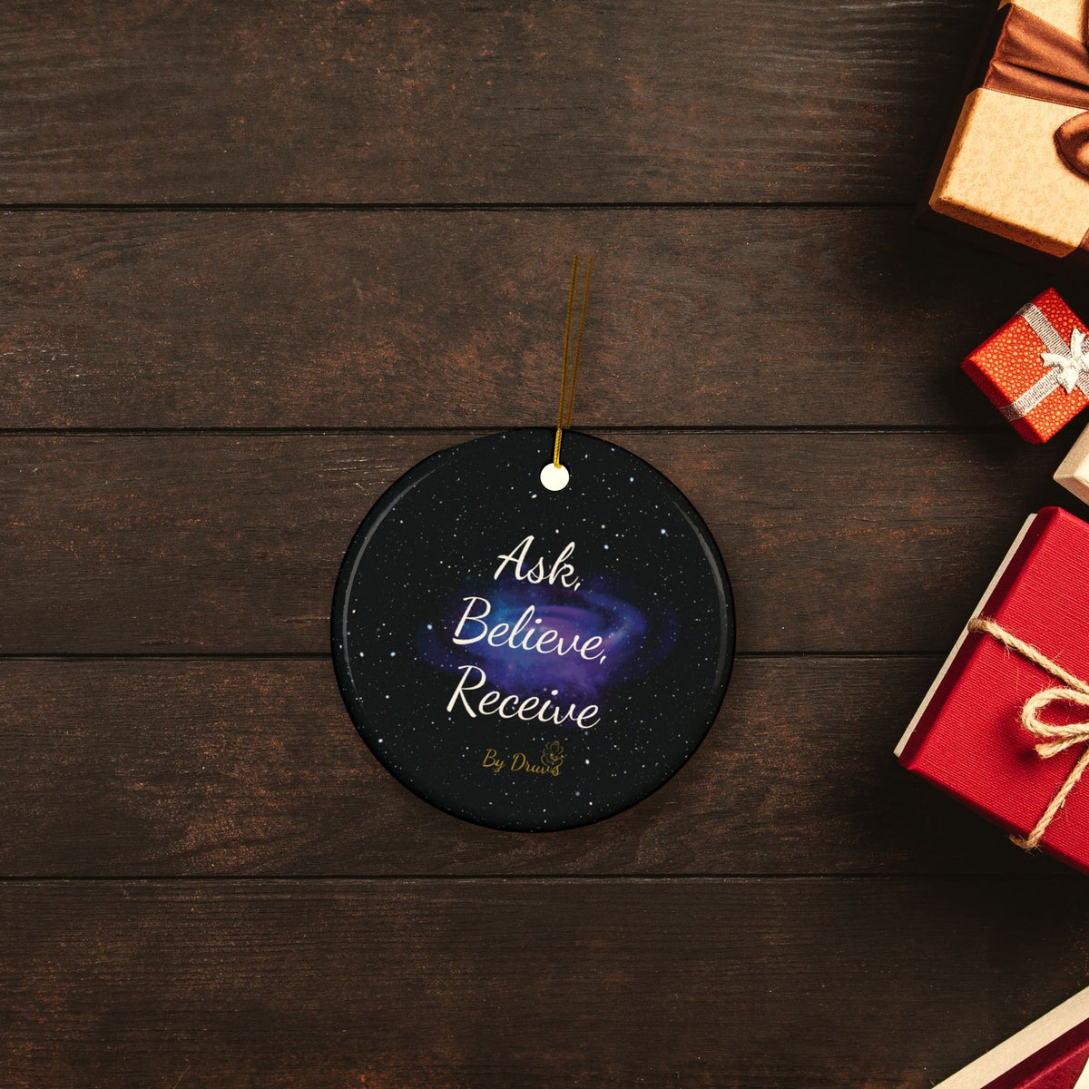 Ask Believe Receive Ceramic Christmas Ornament in a festive flat lay with wrapped Christmas gifts