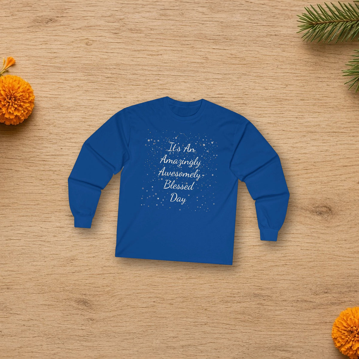Amazingly Awesomely Day long sleeve tee laid flat in a styled lifestyle setting
