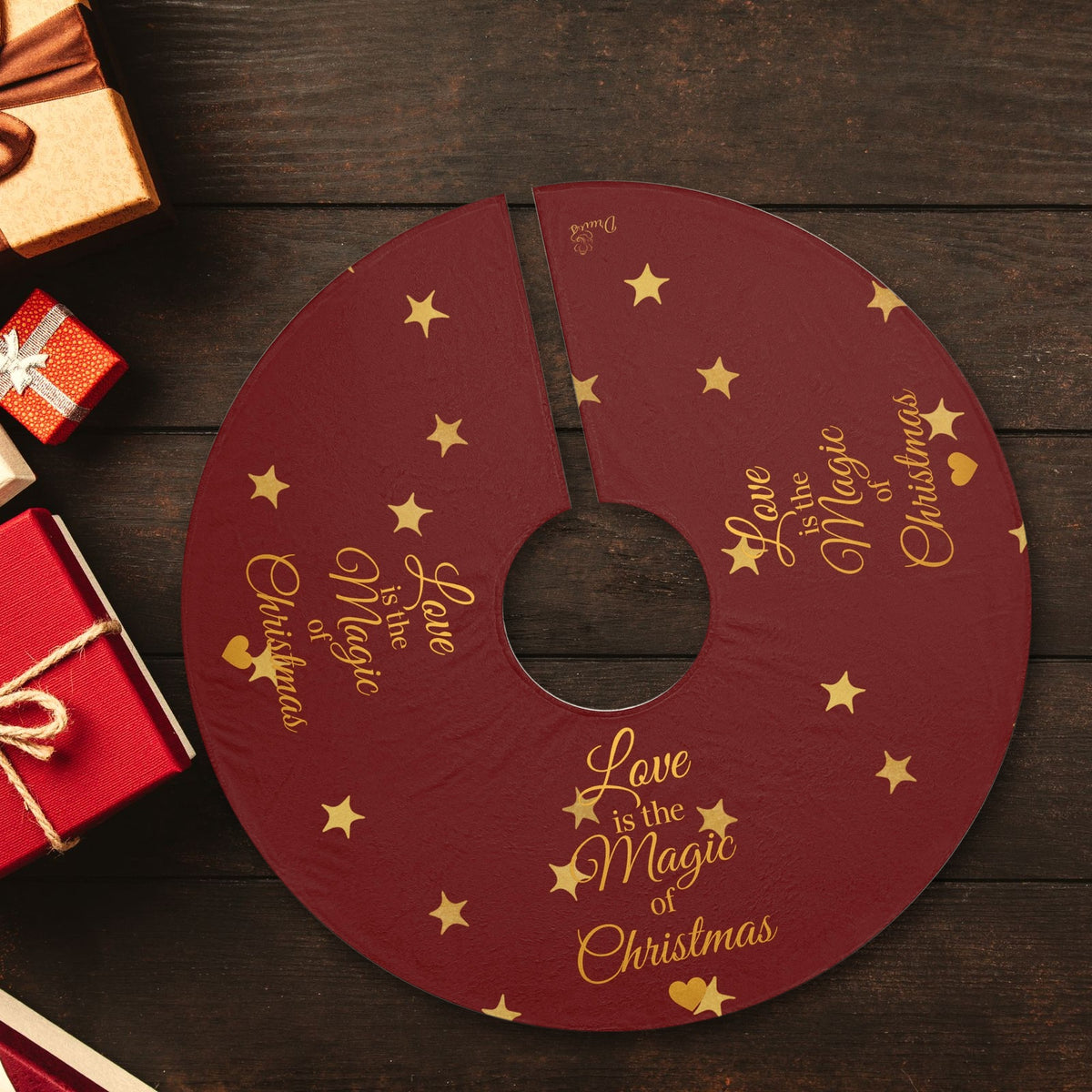 Love Is the Magic of Christmas red and gold Christmas tree skirt laid flat with wrapped presents
