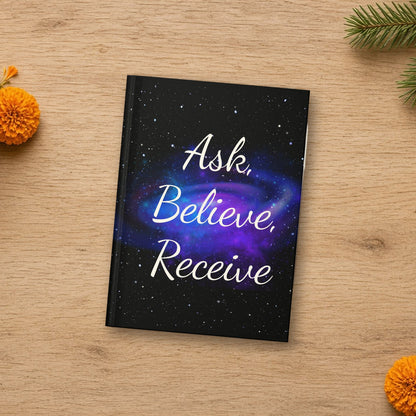 Ask Believe Receive manifestation journal laid flat in a styled lifestyle setting