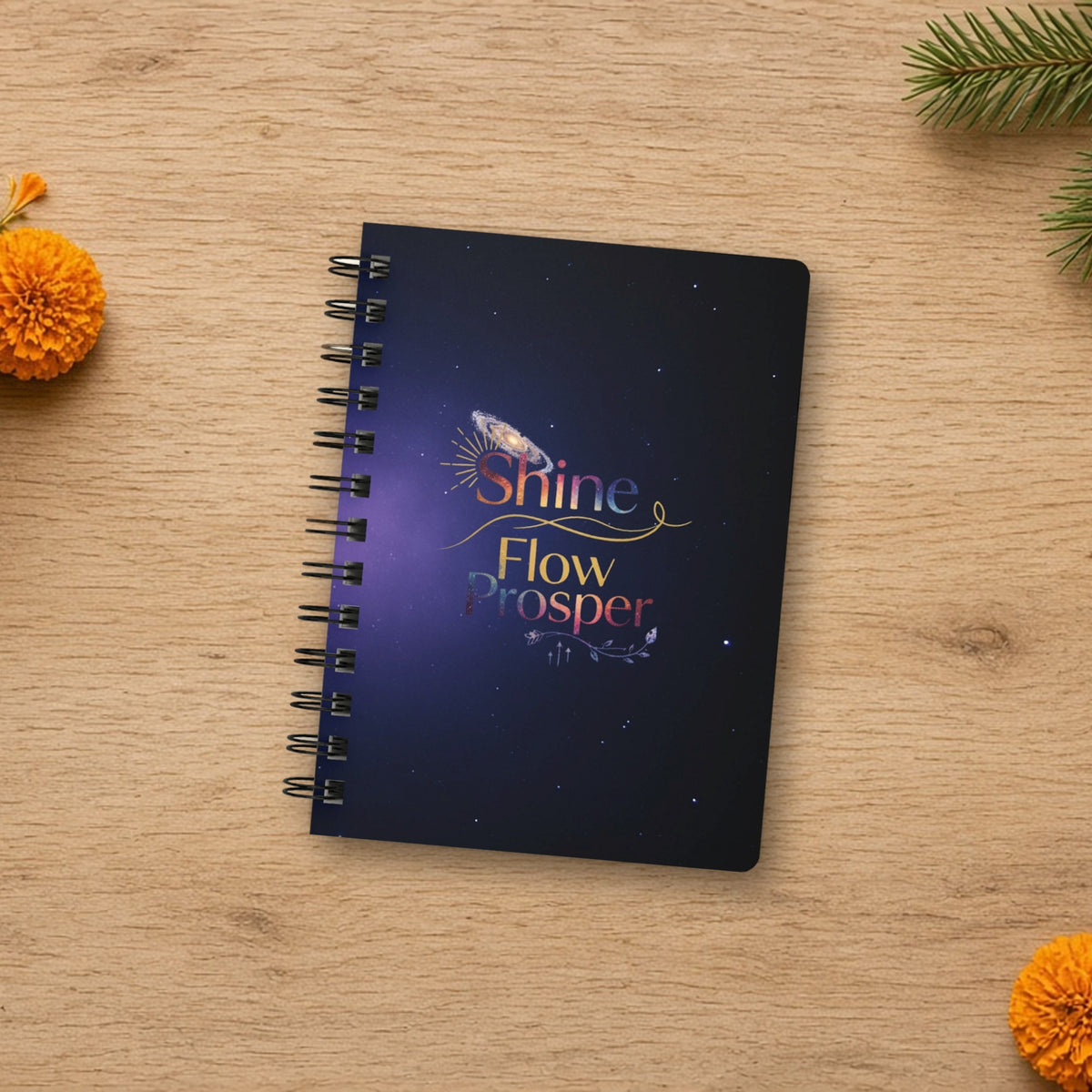 Shine Flow Prosper cosmic spiral journal laid flat in a styled lifestyle setting