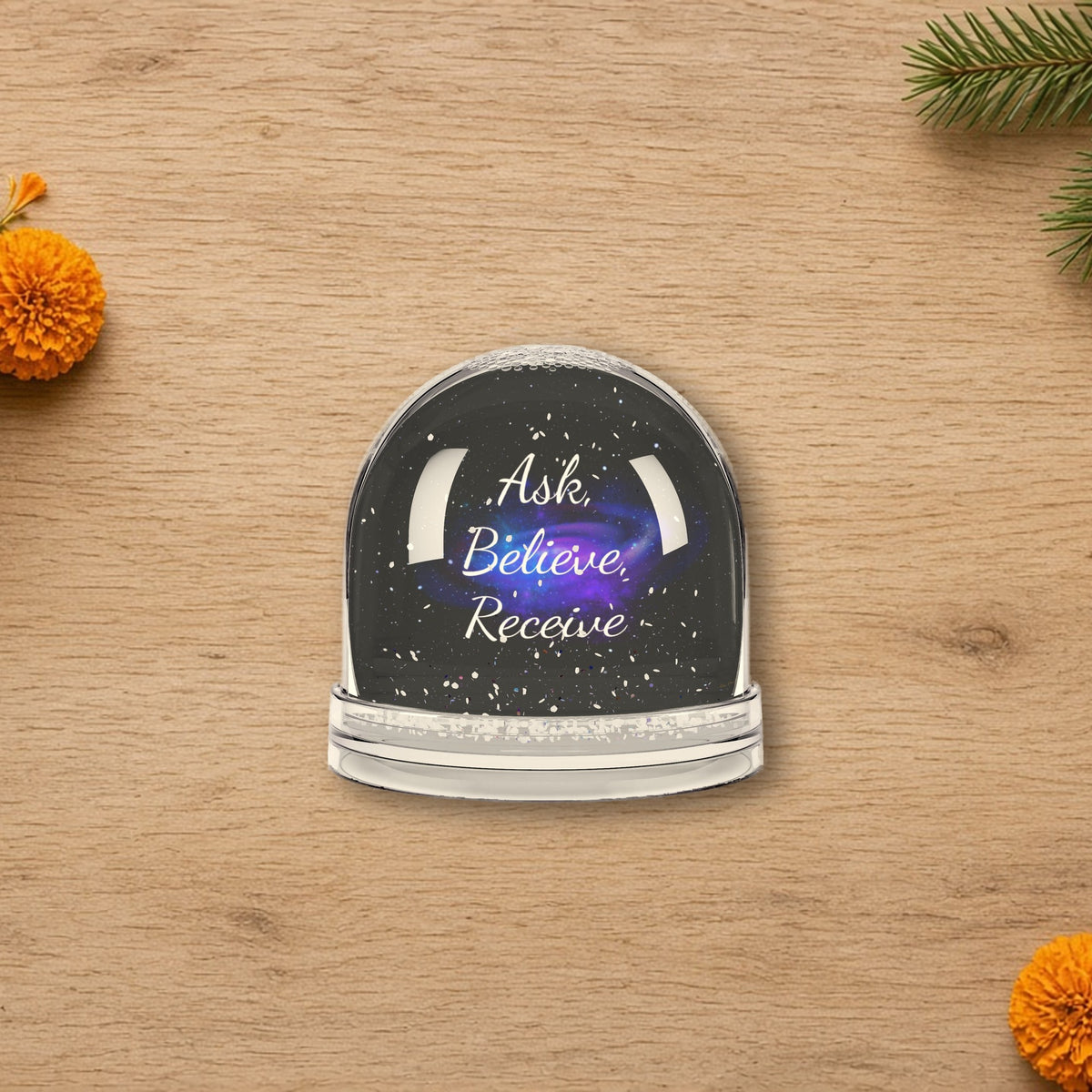 Ask Believe Receive Affirmation Snow Globe styled on a cozy holiday table