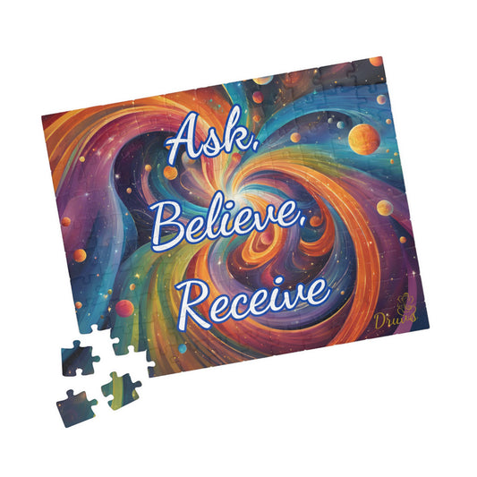 Colorful 252-piece cosmic jigsaw puzzle with swirling galaxy background and white glowing text: “Ask. Believe. Receive.”
