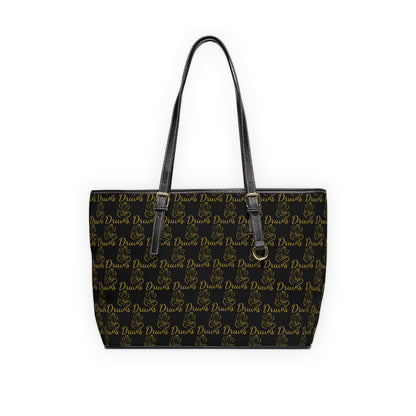 Black leather tote with repeating gold Druvs logo and Ganesha design, double shoulder straps and zip closure.
