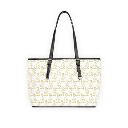White shoulder bag with gold Druvs and Ganesha logo monogram, black straps, and silver zipper.