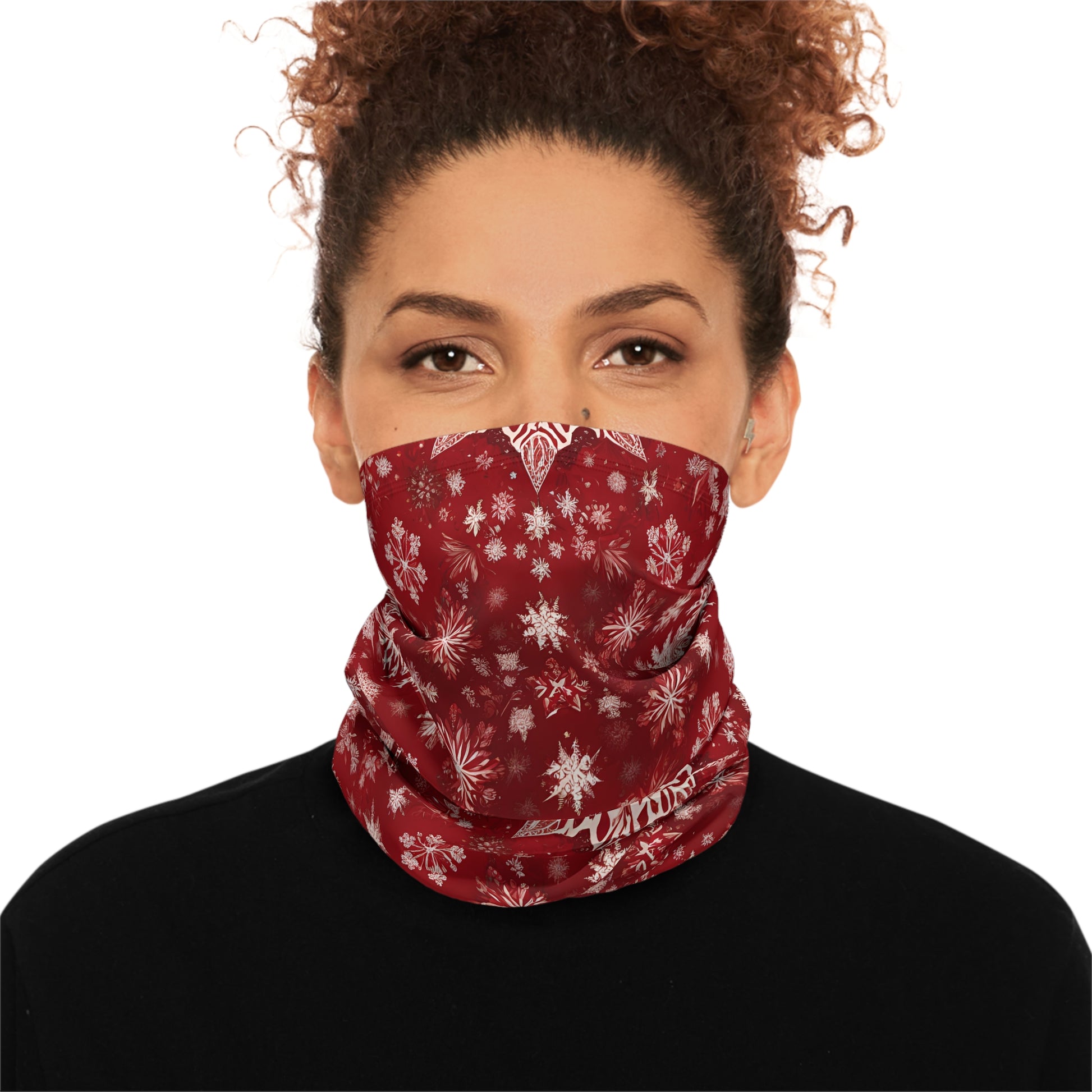 Woman wearing red snowflake gaiter pulled up as a face cover
