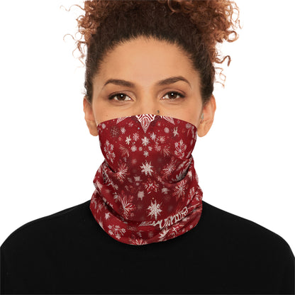 Woman wearing red snowflake gaiter pulled up as a face cover