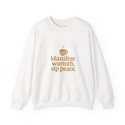 White sweatshirt with warm brown coffee cup graphic and the quote “Manifest warmth, sip peace.” – minimalist winter self-care sweatshirt by Druvs.