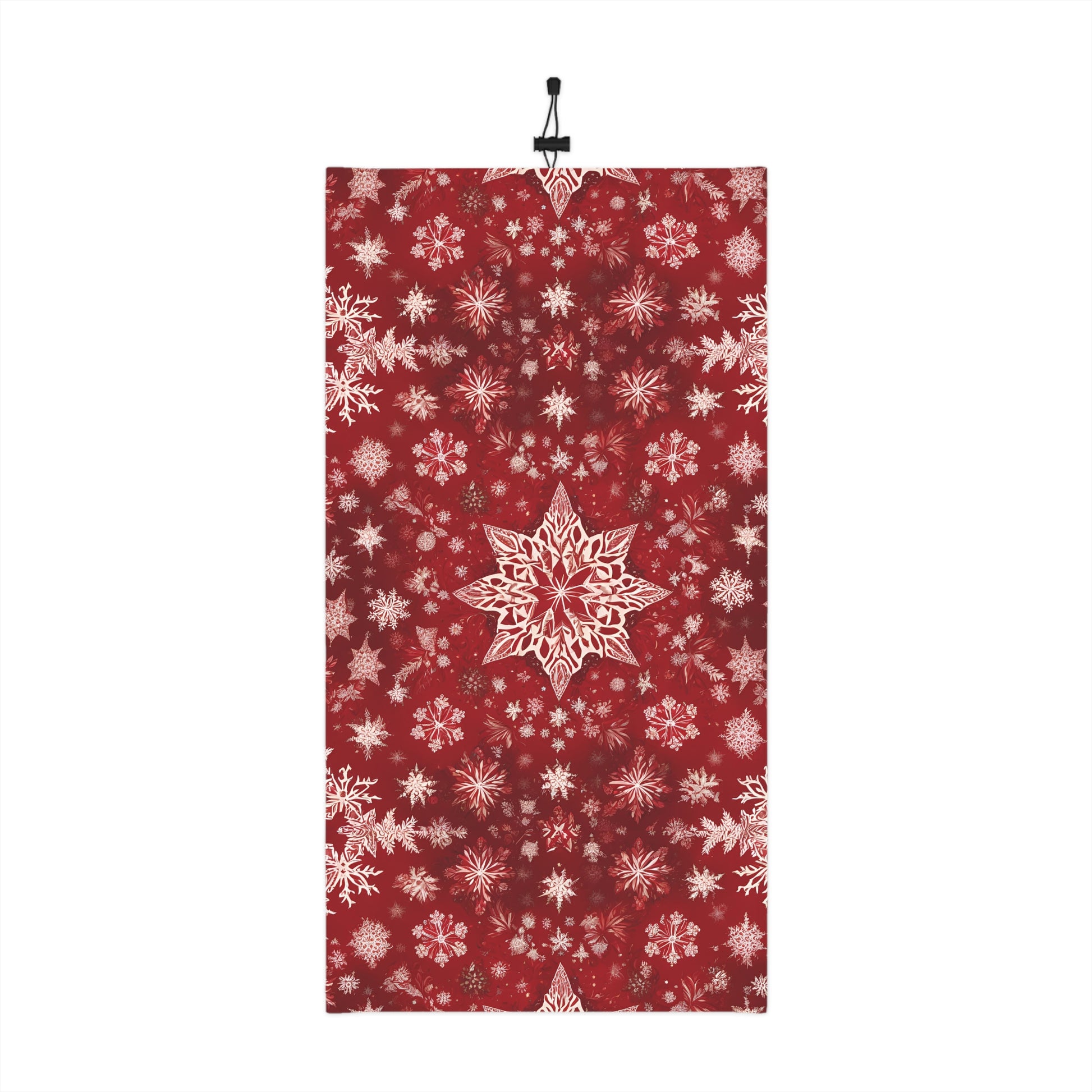 Flatlay of red neck gaiter with white snowflake print and drawstring

