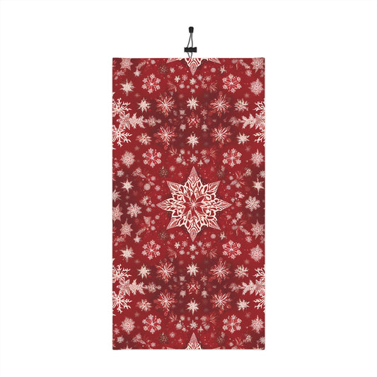 Flatlay of red neck gaiter with white snowflake print and drawstring
