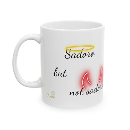 White ceramic mug with the phrase “Sadoro but not sadoro” featuring yellow halo and red devil horn graphics.