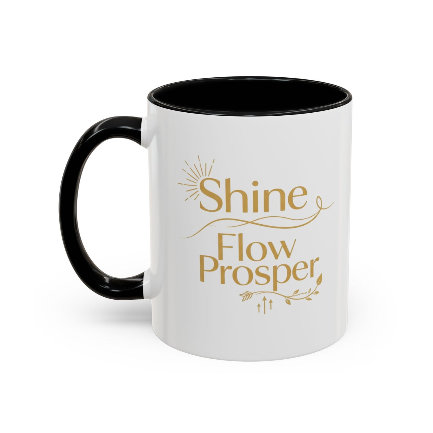 White ceramic mug with black handle and interior, featuring gold “Shine, Flow, Prosper” affirmation text – by Druvs.
