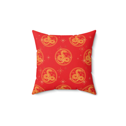 Square throw pillow with red background and repeating golden Chinese snake medallion symbols for Lunar New Year 2025.