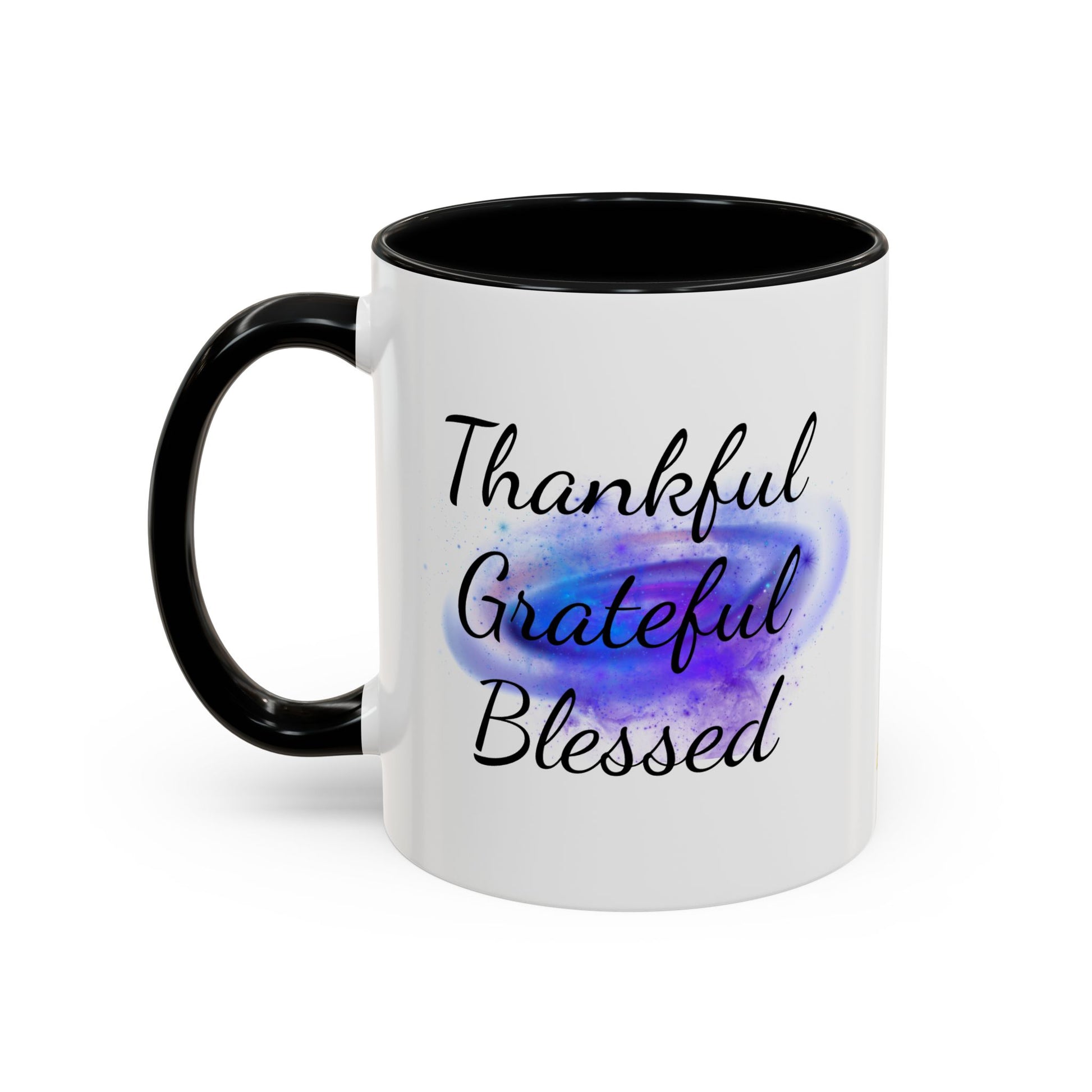 Two-tone white ceramic mug with black handle, featuring “Thankful. Grateful. Blessed.” over a cosmic purple galaxy swirl.