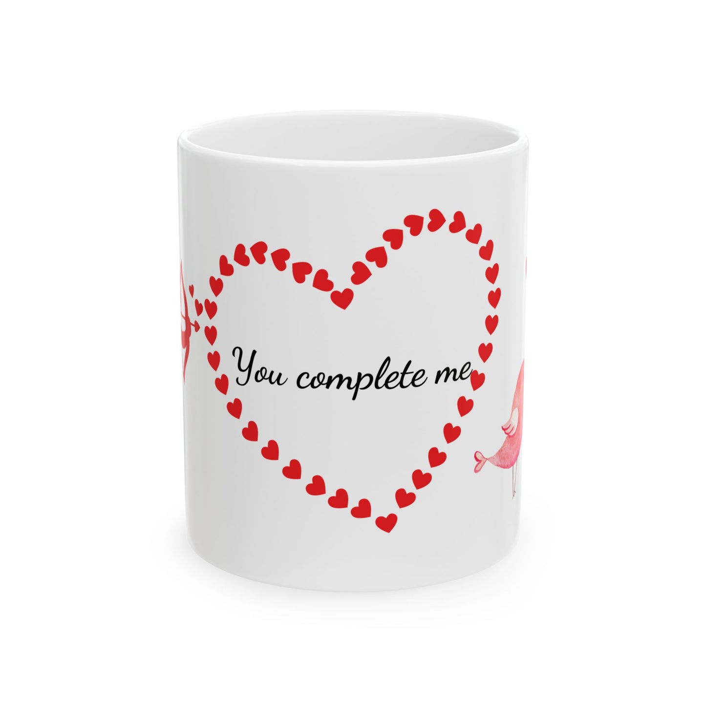 White ceramic mug with red Cupid, heart, and text "You Complete Me