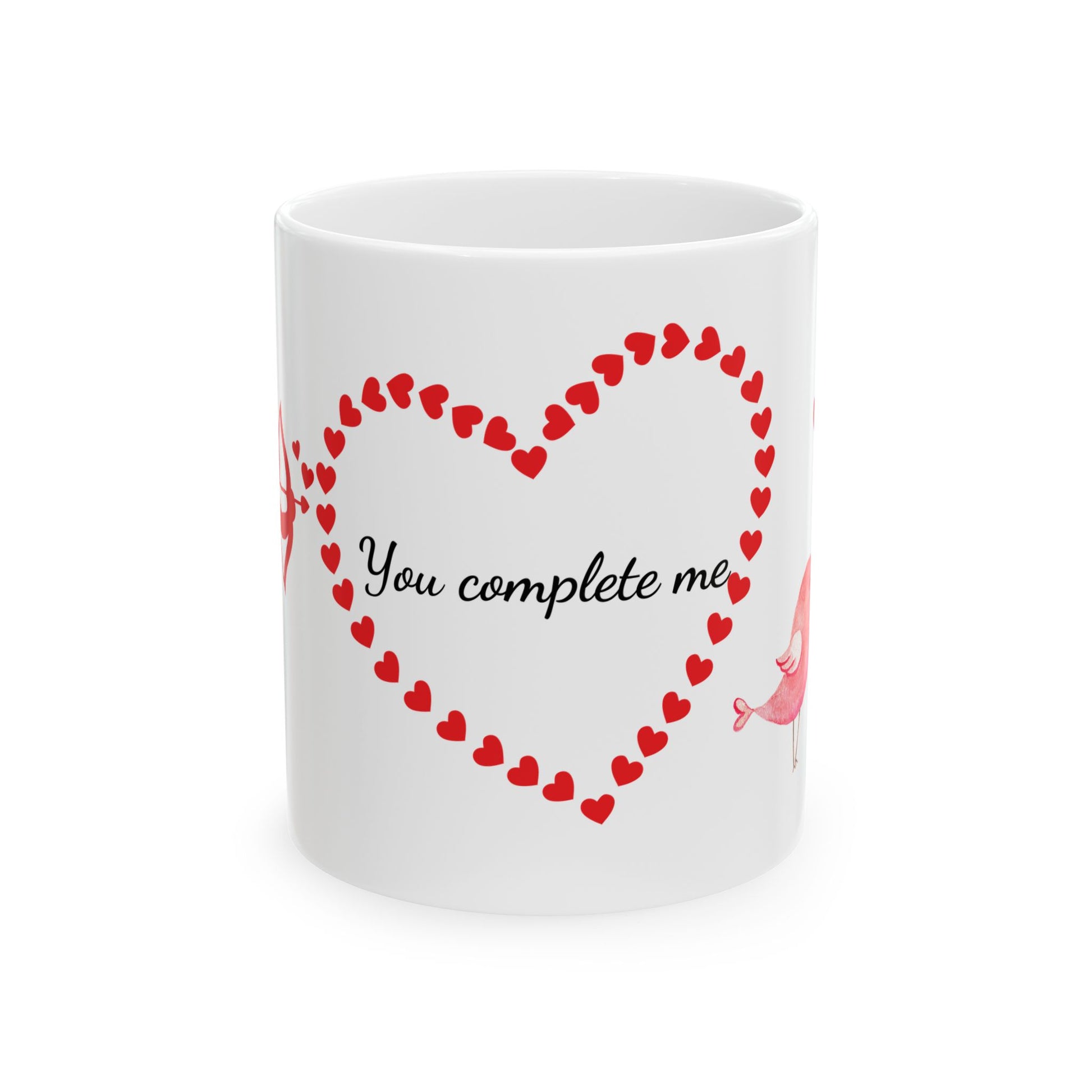 White ceramic mug with red Cupid, heart, and text "You Complete Me