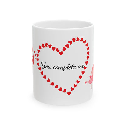 White ceramic mug with red Cupid, heart, and text "You Complete Me