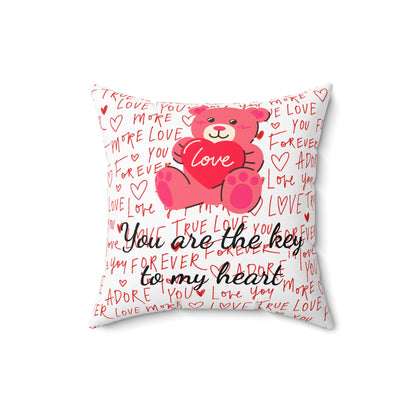 Square pillow with red and white love typography background, teddy bear holding a heart, and text "You are the key to my heart."