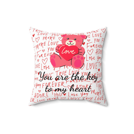 Square pillow with red and white love typography background, teddy bear holding a heart, and text "You are the key to my heart."