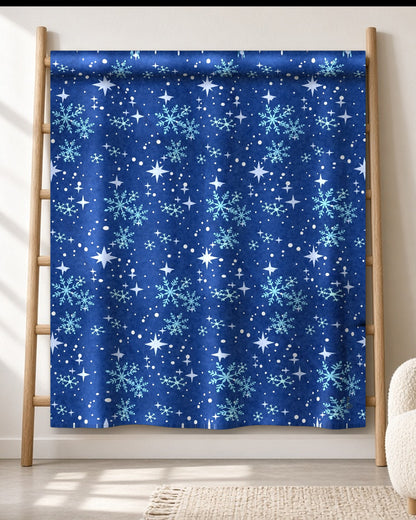 Blue Star & Snowflake winter throw blanket draped on an oak ladder in a bright living room